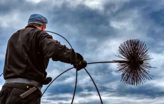 Chimney brush and rods against an overcast sky